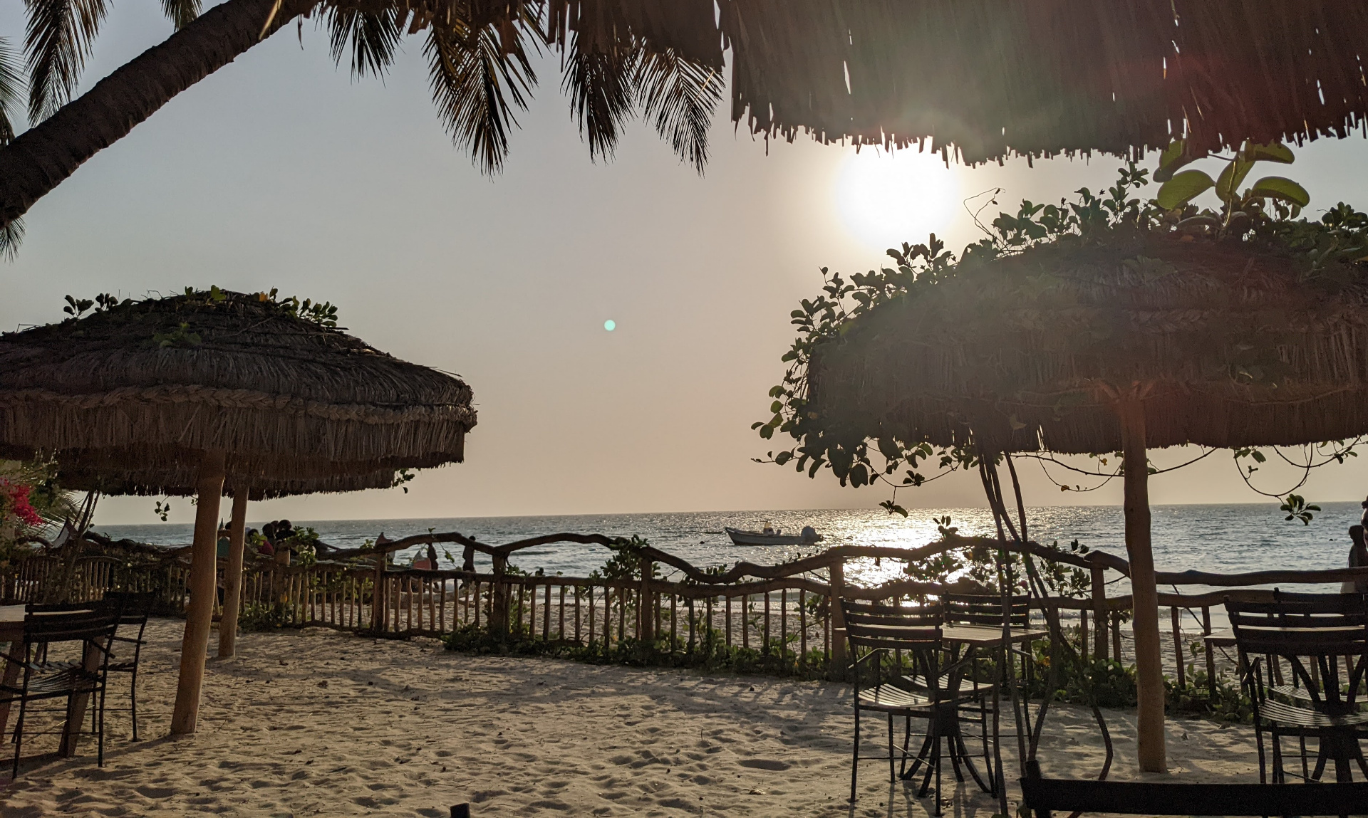 Beach at dusk with thatched umbrellas